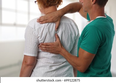 Senior Woman Having Chiropractic Back Adjustment. Osteopathy, Alternative Medicine, Pain Relief Concept. Physiotherapy, Sport Injury Rehabilitation