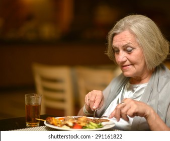 Senior Woman Having A Dinner At Restaurant