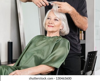 Senior Woman Having Hair Cut At Beauty Salon