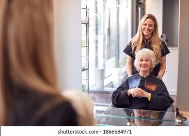 Senior Woman Having Hair Cut By Female Stylist In Hairdressing Salon - Powered by Shutterstock