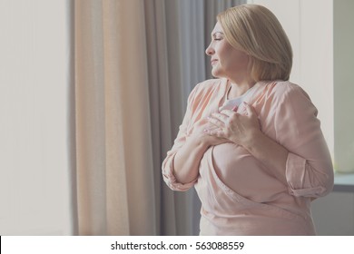 Senior Woman Having Heart Attack At Home