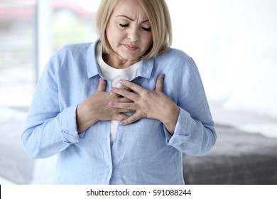 Senior Woman Having Heart Attack At Home