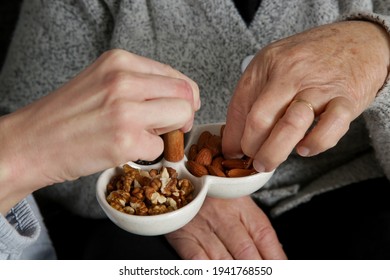 Senior Woman Having Nuts And Dried Fruits For Snack. 
Healthy Dieting And Smart Snack Choice.