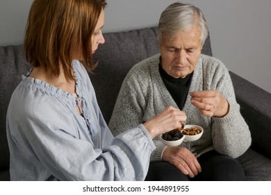 Senior Woman Having Nuts And Dried Fruits For Snack. Healthy Dieting And Smart Snack Choice.	