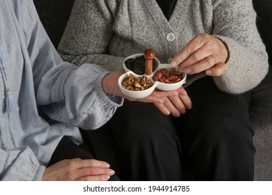 Senior Woman Having Nuts And Dried Fruits For Snack. Healthy Dieting And Smart Snack Choice.