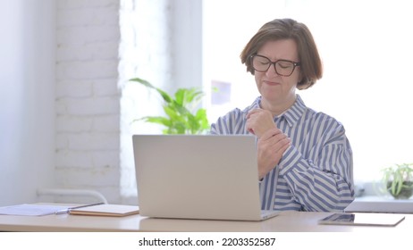 Senior Woman Having Wrist Pain While Using Laptop