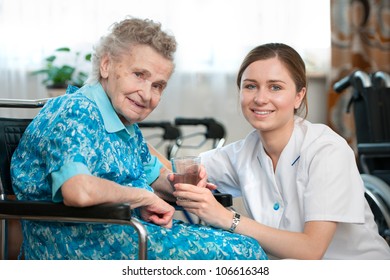 Senior Woman With Her Caregiver At Home