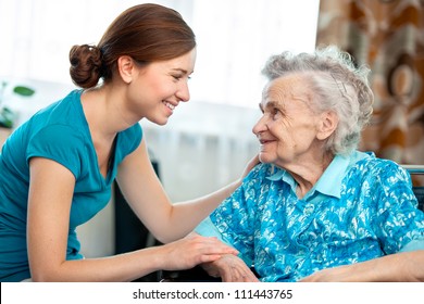 Senior Woman With Her Caregiver At Home