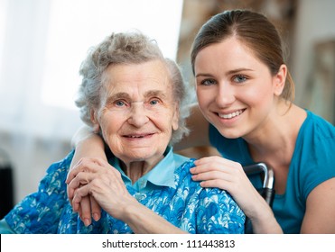 Senior Woman With Her Caregiver At Home