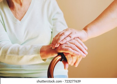 Senior Woman With Her Caregiver At Home. Concept Senior People Health Care.