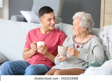 Senior Woman With Her Grandson Resting At Home