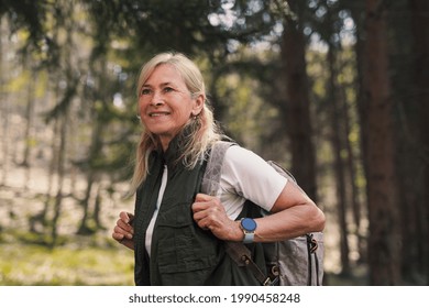 Senior woman hiker outdoors walking in forest in nature, walking. - Powered by Shutterstock