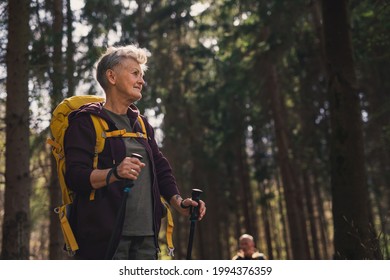 Senior woman hiker outdoors walking in forest in nature, walking. - Powered by Shutterstock