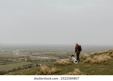 Senior woman hiking with dog hiking on mountain trail. Senior woman and dog traveling. Woman and dog enjoying travel outdoor adventure. Hiking on nature trail, outdoor activity. Adventure in nature. - Powered by Shutterstock