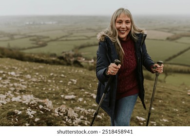 Senior woman hiking mountain, countryside, outdoor travel. Senior woman walking in nature. Health and wellness for senior retired woman. Woman enjoying a walk in the countryside nature. - Powered by Shutterstock