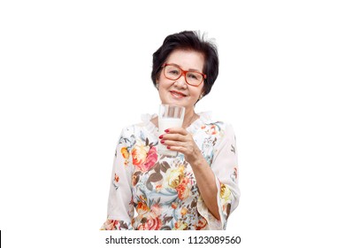 Senior Woman Holding A Glass Of Milk , Isolated On White Background.