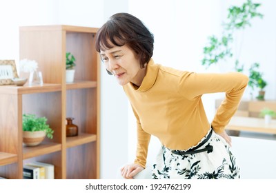 Senior woman holding her hips