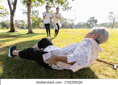 Senior Woman Is Holding Her Hip,severe Pain In Her Muscle,broken Bone,injury To The Waist,old Elderly Lying On The Ground,she Fell Down While Strolling,daughter,granddaughter Ran To Help Grandmother