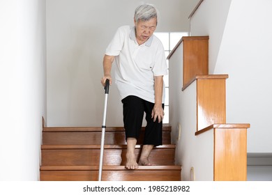 Senior woman holding her pain knee with hand while walking down the stairs,elderly suffering from Osteoarthritis of the knee,Rheumatic disease,painful in the knee joint or bone degeneration in old age
