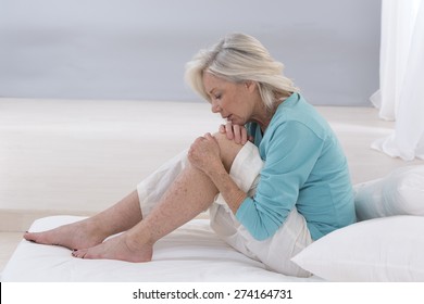 Senior  woman holding the knee with pain 