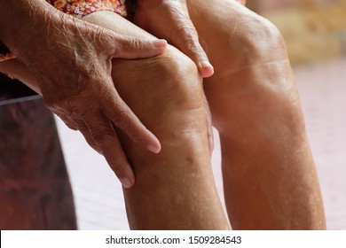 Senior woman holding the knee with pain,Elderly legs, knee pain, osteoarthritis.