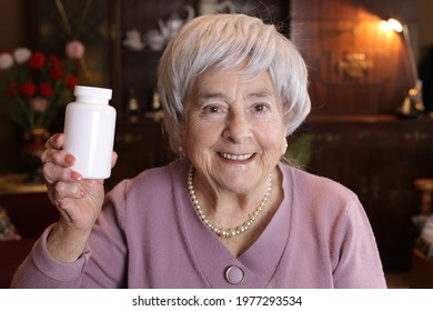 Senior woman holding pills bottle - Powered by Shutterstock