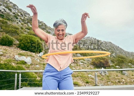 Senior woman, hoop and fitness outdoor with smile, training and playful on balcony, mountains and healthy. Mature lady, exercise and happy for wellness, stomach workout and toys on rooftop in Hawaii