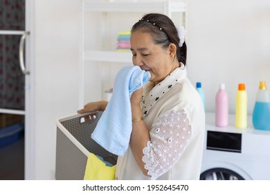 Senior Woman House Keeper Smile With Good Smell Cloth After Laundry Cleaning