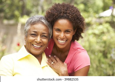 Senior Woman Hugging Adult Daughter