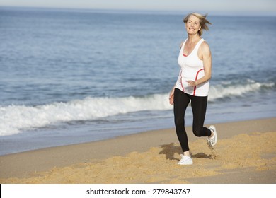 Senior Woman Jogging Along Beach - Powered by Shutterstock