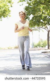 Senior Woman Jogging In Park