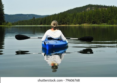Senior Woman Kayaking On Lake
