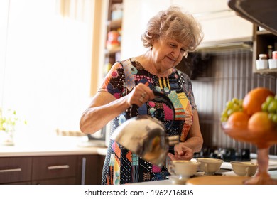 Senior woman with kettle pouring hot water into cup in kitchen
 - Powered by Shutterstock