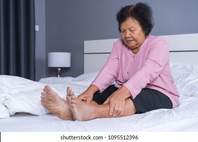 Senior Woman With Leg Pain In A Bed