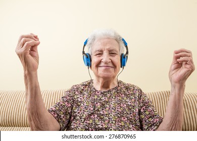senior woman listening music and dancing