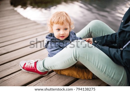 Senior woman with little boy at the lake.