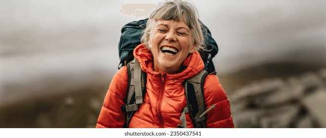 Senior woman living an active lifestyle in her retirement, embarking on a scenic hike and enjoying life to the fullest. This elderly hiker's passion for adventure embraces nature for overall wellness.