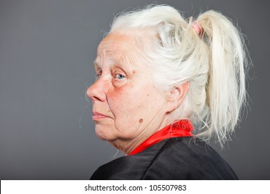 Senior Woman With Long Grey Hair Wearing Black And Red Kimono. Studio Shot Isolated On Grey Background.