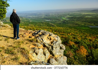 Senior Woman Looking Across The Ozarks Of Arkansas Landscape From A Hiking Trail In Mount Magazine State Park .