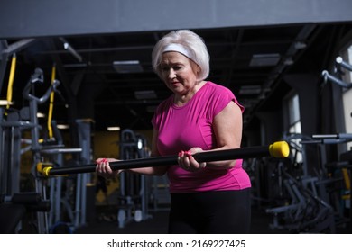 Senior Woman Looking Focused, Doing Bicep Curls