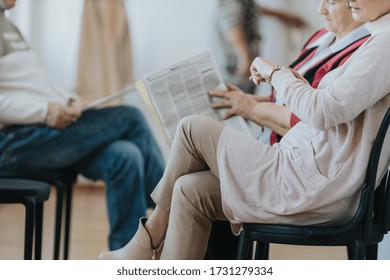 Senior woman looking at the watch waiting in a line in doctor's office - Powered by Shutterstock