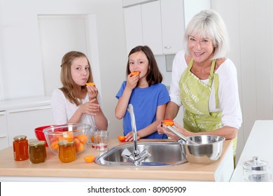 Senior woman making apricot jam with grandkids - Powered by Shutterstock