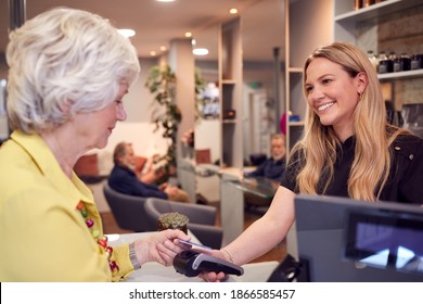 Senior Woman Making Contactless Payment To Stylist In Salon With Credit Card - Powered by Shutterstock