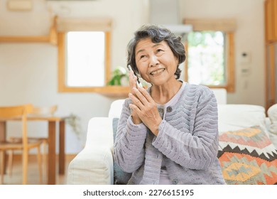 Senior woman making a phone call at home - Powered by Shutterstock