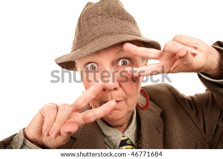 Senior woman in male clothing making fashionable dance hand gesture