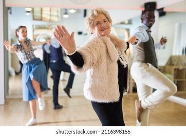 Senior Woman And Man Dancing Swing In