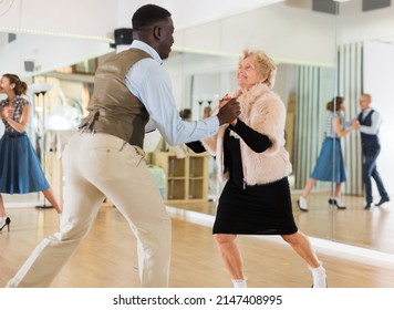 Senior Woman And Man Dancing Swing In