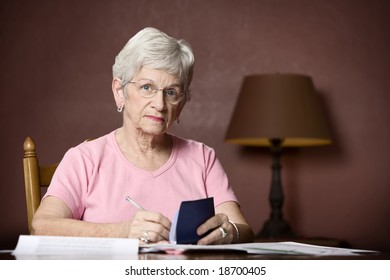 Senior Woman With Many Bills And Notices