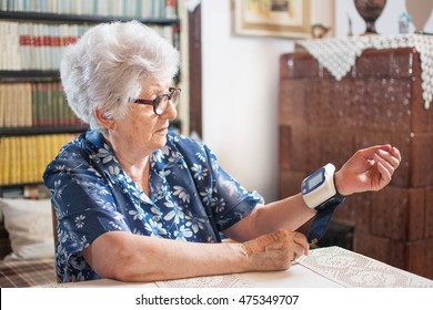 Senior Woman Measuring Her Blood Pressure At Home.