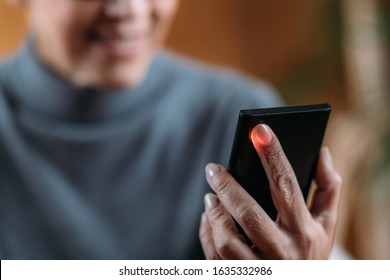 Senior Woman Measuring Pulse Or Heart Rate With Smart Phone